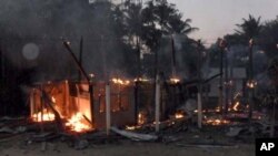 A house burns in a Thai village near a 11th-century Preah Vihear temple at the border between Thailand and Cambodia February 4, 2011. Thai and Cambodian soldiers exchanged fire in a two-hour border clash on Friday that killed two Cambodian soldiers and a 