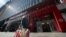 A woman carries Target shopping bags as she leaves the store, April 19, 2021 in New York.