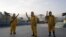 FILE - Municipal workers wait before spraying insecticide at Sambodrome in Rio de Janeiro, Brazil, Jan. 26, 2016.