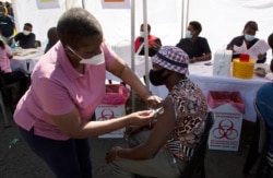 A patient receives a Johnson &amp; Johnson vaccine at a pop-up vaccination center in Soweto, South Africa, Aug. 20, 2021.