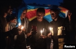 FILE - Members of civil society hold burning candles as they attend a collective mourning organised in memory of the victims of the ongoing fighting between the M23 rebels and the FARDC in Goma,North Kivu province of the Democratic Republic of Congo February 7, 2024.