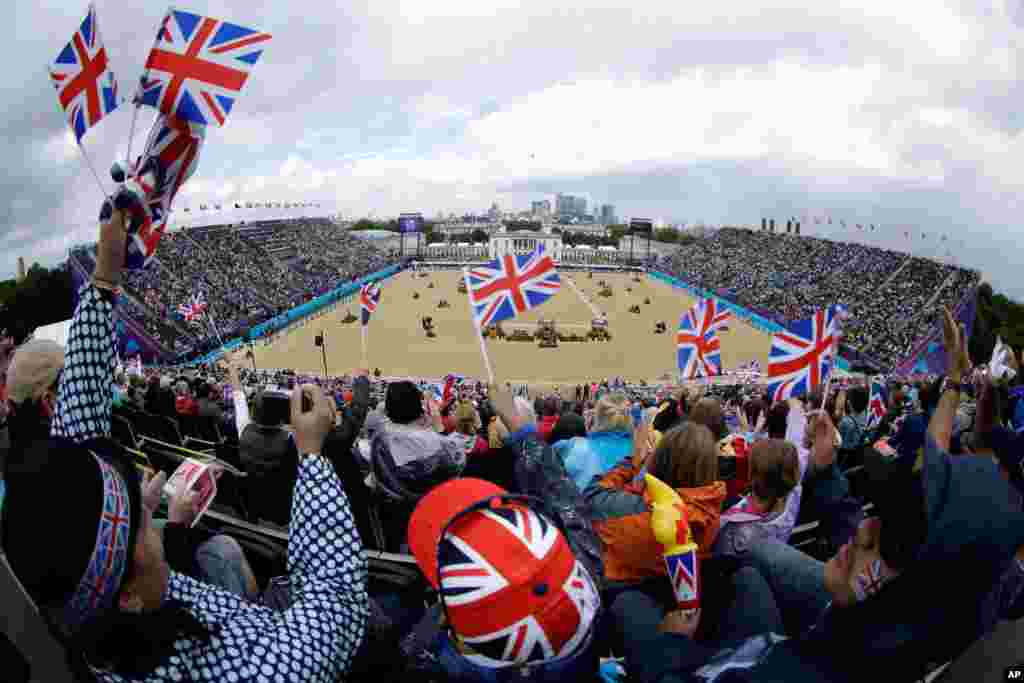 British fans watch Richard Davison of Great Britain compete with his horse Artemis during the equestrian dressage.
