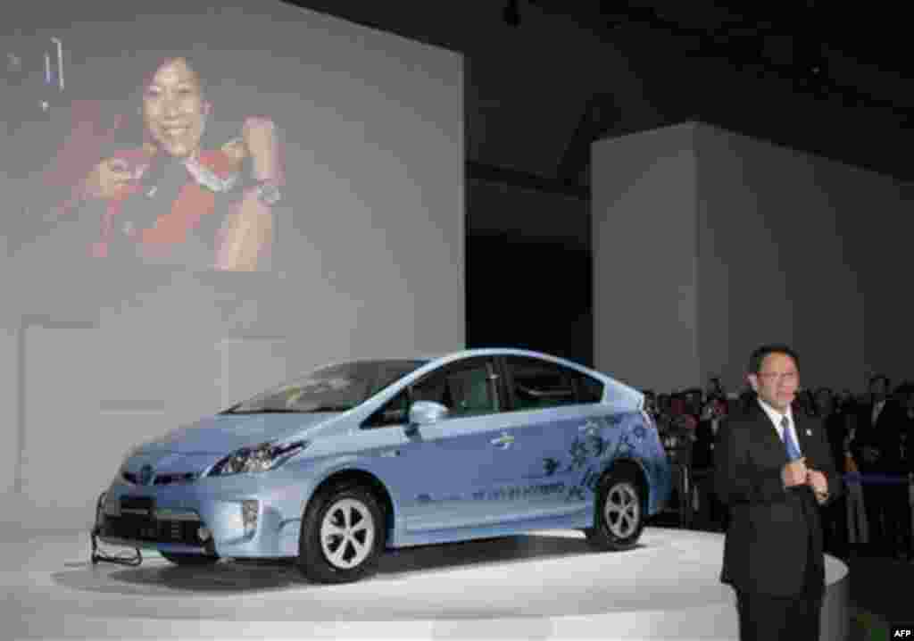 Akio Toyoda, president of Toyota Motor Corp., speaks in front of "Prius PHV" at the press conference during the press preview of Tokyo Motor Show in Tokyo, Wednesday, Nov. 30, 2011. The Tokyo Motor Show opens to the public this weekend. (AP Photo/Koji Sas