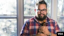 This Sept. 18, 2018 photo Provided by the John D. and Catherine T. MacArthur Foundation shows Robert Vijay Gupta, Founder and Artistic Director of Street Symphony, posing with his violin in his house in Los Angeles. 