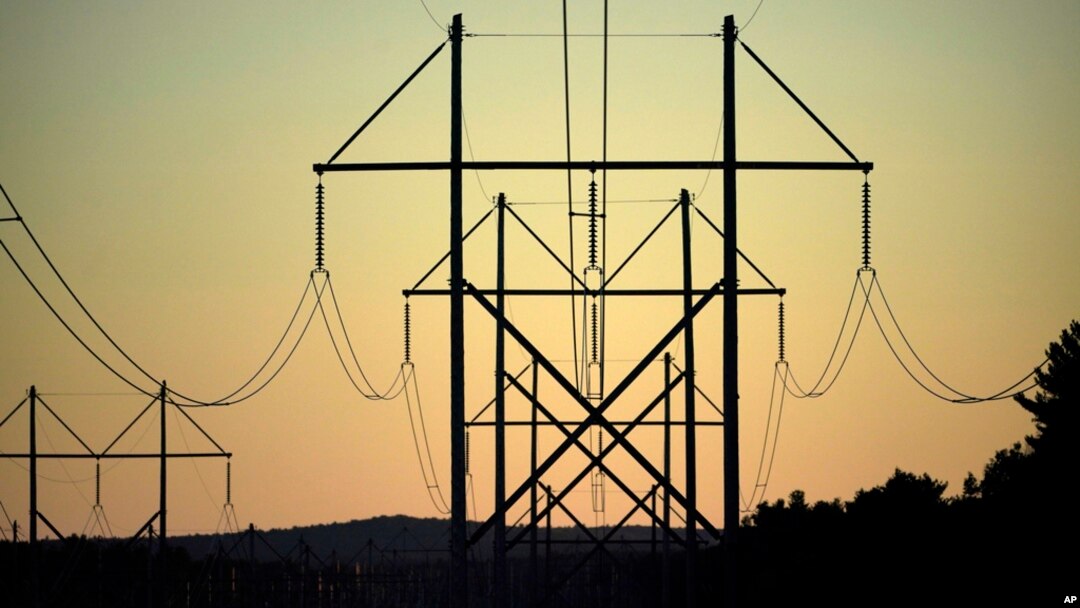 FILE - Power transmission lines stretch above the treetops in Maine, on Oct. 6, 2021. A former U.S. Marine was sentenced Oct. 28, 2024, for his role in a plot targeting U.S. power facilities.