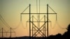 FILE - Power transmission lines stretch above the treetops in Maine, on Oct. 6, 2021. A former U.S. Marine was sentenced Oct. 28, 2024, for his role in a plot targeting U.S. power facilities.