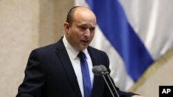 Israel's new prime minister, Naftali Bennett, speaks during a Knesset session in Jerusalem, June 13, 2021.