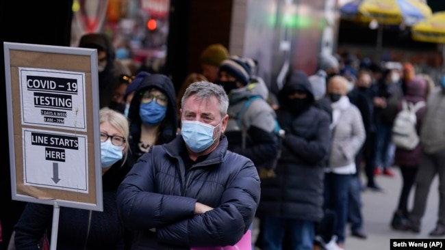 FILE - People wait in line at a COVID testing site in NYC on Dec. 13, 2021. (AP Photo/Seth Wenig, File)