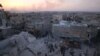 Men inspect damage after an airstrike on Aleppo's rebel held al-Hallak neighborhood, Syria June 2, 2016. 