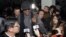Flamboyant former NBA star Dennis Rodman is surrounded by journalists upon arrival at Pyongyang Airport, North Korea, Feb. 26, 2013.