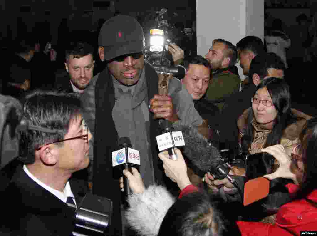 Flamboyant former NBA star Dennis Rodman is surrounded by journalists upon arrival at Pyongyang Airport, North Korea, Feb. 26, 2013.