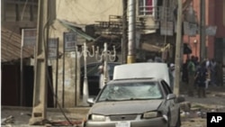 A body is seen at the site of a bomb explosion at a road in Kaduna, Nigeria, April 8, 2012.