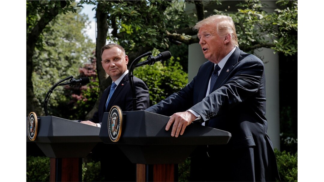 FILE - Poland's President Andrzej Duda listens to U.S. President Donald Trump during a joint news conference in the Rose Garden at the White House in Washington, June 24, 2020.