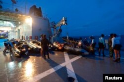 FILE - Indonesian navy divers are seen on board their vessel preparing for an underwater mission in the Java Sea January 9, 2015.