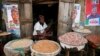 FILE - Latefat Alao, 56, a ethnic Yoruba Muslim woman, waits for customers in front of her in Beere market in Ibadan, southwest Nigeria, Jan. 29, 2015. 