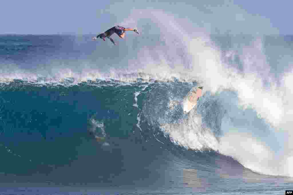 An unknown surfer wipes out during the Vans World Cup of Surfing at Backdoor Pipeline on the north shore of Oahu, Hawaii, Nov. 27, 2019.