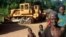 Congolese people standing in front of two bulldozers in Yayolo, Democratic Republic of Congo, October 2004. (file photo)