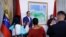 People take photos during an event to unveil a map of Venezuela showing Guyana's Essequibo region as part of the country, in Caracas, Venezuela, on Dec. 8, 2023.