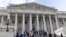 Members of the House of Representatives walk down the steps of Capitol Hill in Washington, Friday, March 27, 2020, after passing a coronavirus rescue package.