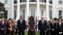 President Barack Obama, first lady Michelle Obama, Vice President Joe Biden, and others, stand on the South Lawn of the White House in Washington, as they observe a moment of silence to mark the 13th anniversary of the 9/11 attacks.