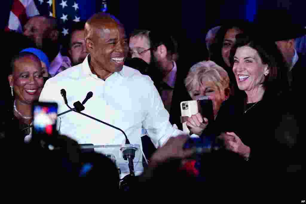 New York Governor Kathy Hochul, right, congratulates New York City Mayor-elect Eric Adams as he speaks to supporters, Nov. 2, 2021, in New York.