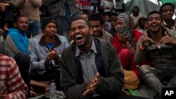 Rescued migrants enjoy a music performance aboard of Golfo Azurro rescue boat a day after members of Proactiva Open Arms NGO picked them up, April 7, 2017.