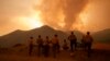 FILE - Firefighters monitor the advancing Line Fire in Angelus Oaks, Calif., Sept. 9, 2024. 