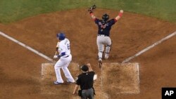 Home plate umpire Jeff Nelson makes the call while Boston Red Sox catcher Christian Vazquez celebrates as Los Angeles Dodgers' Manny Machado strikes out to end Game 5 of baseball's World Series against the Los Angeles Dodgers, Oct. 28, 2018.