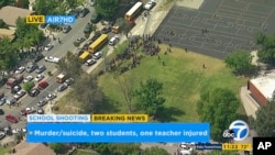 In this frame from video provided by KABC-TV, faculty and students evacuate North Park Elementary School as emergency personnel respond to a shooting inside in San Bernardino, California, April 10, 2017.