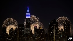 FILE - Fireworks light up the Empire State Building along the Manhattan skyline in New York. 