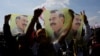 FILE - Supporters of the pro-Kurdish DEM party display flags with a portrait of jailed PKK leader Abdullah Ocalan in Istanbul, Turkey, on March 17, 2024. Ocalan has been imprisoned in solitary confinement on an island near Istanbul since 1999.