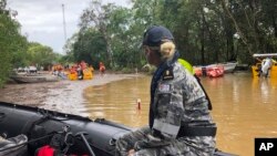 Royal Australian Navy personnel work with civilian emergency services to evacuate members of the public in Cairns, Australia, Dec. 18, 2023.