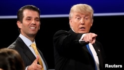 FILE - Donald Trump Jr. (L) gives a thumbs up beside his father Republican U.S. presidential nominee Donald Trump (R) after Trump's debate against Democratic nominee Hillary Clinton at Hofstra University in Hempstead, New York, Sept, 26, 2016. 