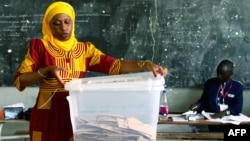 An electoral worker opens a ballot box following the closure of polling stations at the end of Senegal's general election, on July 30, 2017 in Dakar.