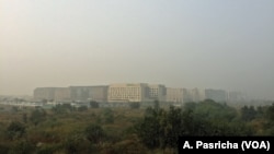 Buildings in New Delhi, India, are shrouded in a grey haze as air pollution levels reaches deadly levels this week, Nov. 6, 2016. 