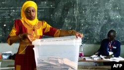 An electoral worker opens a ballot box following the closure of polling stations at the end of Senegal's general election, on July 30, 2017 in Dakar.