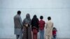 Najia, second left, pose with her family in Kabul, Afghanistan, Oct. 1, 2021. Soon after the Taliban took control of Kabul, the family sold their households and used the money to try to cross into Pakistan. 