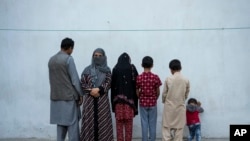 Najia, second left, pose with her family in Kabul, Afghanistan, Oct. 1, 2021. Soon after the Taliban took control of Kabul, the family sold their households and used the money to try to cross into Pakistan. 