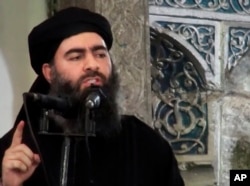 FILE - This image made from video posted on a militant website July 5, 2014, purports to show the leader of the Islamic State group, Abu Bakr al-Baghdadi, delivering a sermon at a mosque in Iraq.