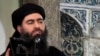 FILE - This image made from video posted on a militant website July 5, 2014, purports to show the leader of the Islamic State group, Abu Bakr al-Baghdadi, delivering a sermon at a mosque in Iraq.