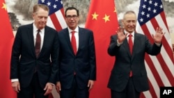 FILE - Chinese Vice Premier Liu He, right, gestures as U.S. Treasury Secretary Steven Mnuchin, center, chats with his Trade Representative Robert Lighthizer before their meeting in Beijing, May 1, 2019.