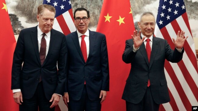 FILE - Chinese Vice Premier Liu He, right, gestures as U.S. Treasury Secretary Steven Mnuchin, center, chats with his Trade Representative Robert Lighthizer before their meeting in Beijing, May 1, 2019.