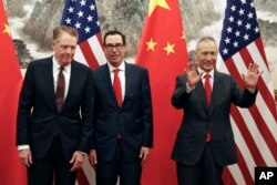 FILE - Chinese Vice Premier Liu He (R) gestures as U.S. Treasury Secretary Steven Mnuchin (C) chats with his Trade Representative Robert Lighthizer (L) before their meeting in Beijing, May 1, 2019.