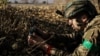 A member of Ukraine's 24th mechanized brigade installs a landmine on the outskirts of the town of Chasiv Yar in Donetsk region, Ukraine October 30, 2024. Ukrainian Armed Forces/Handout via REUTERS 