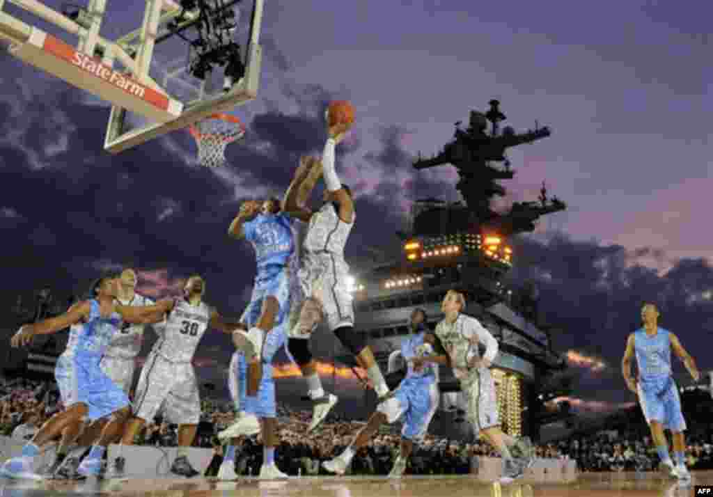 North Carolina forward John Henson (31) tries to block a shot by Michigan State center Adreian Payne (5) during the first half of the Carrier Classic NCAA college basketball game aboard the USS Carl Vinson, Friday, Nov. 11, 2011, in Coronado, Calif. (AP 