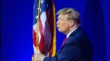 FILE — Former US president and 2024 presidential hopeful Donald Trump kisses the US flag as he arrives to speak during the annual Conservative Political Action Conference (CPAC) meeting on February 24, 2024, in National Harbor, Maryland. 