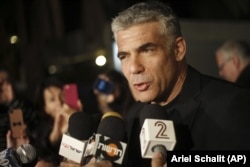 Yair Lapid, leader of Yesh Atid party gives a statement outside his home in Tel Aviv, Wednesday, Jan. 23, 2013.