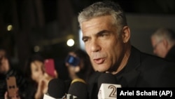 Yair Lapid, leader of Yesh Atid party gives a statement outside his home in Tel Aviv, Wednesday, Jan. 23, 2013. (AP Photo/Ariel Schalit)