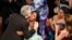 Yalitza Aparicio, right, congratulates Alfonso Cuaron in the audience as he is announced the winner of the award for best cinematography for "Roma" at the Oscars on Sunday, Feb. 24, 2019, at the Dolby Theatre in Los Angeles.