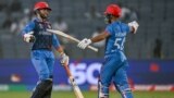 Afghanistan's Azmatullah Omarzai (L) celebrates with his captain Hashmatullah Shahidi after scoring a half-century (50 runs) during the 2023 ICC Men's Cricket World Cup one-day international (ODI) match between Afghanistan and Sri Lanka at the Maharashtra